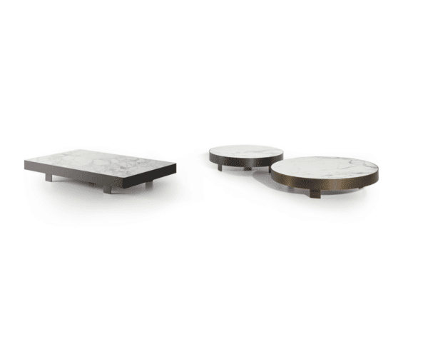 A set of three coffee tables with a low-profile design. The tabletops are made of white marble featuring subtle grey veining.