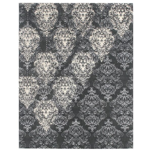 A deep charcoal grey rug featuring an intricate damask pattern with lighter grey and ivory patterns.